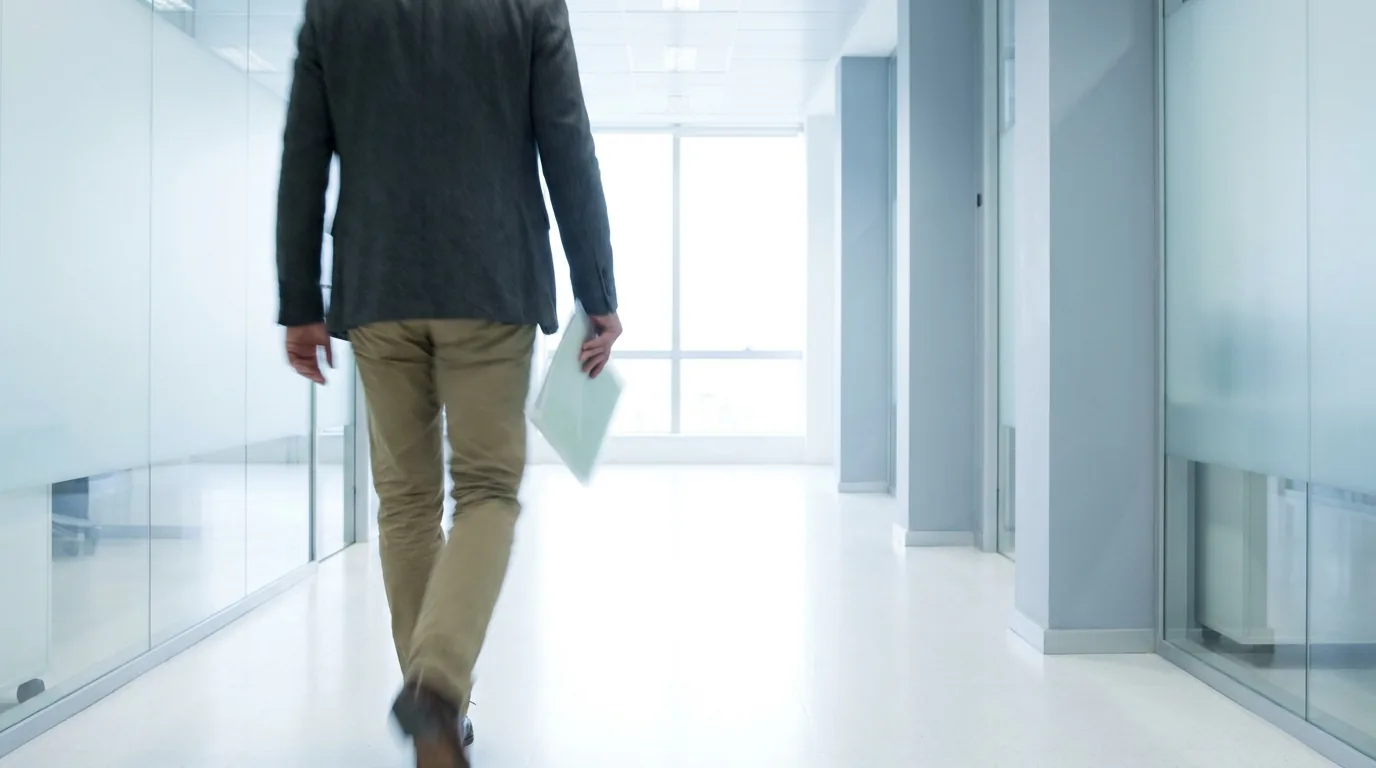 What a CPA does: a professional carrying a folder through an office corridor